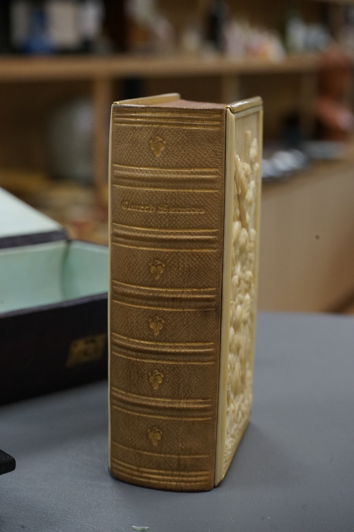 A leather boxed Common Prayer book with relief Crucifixion scene and advertising ink blotter, The Brazilian Submarine Telegraph 13cm high